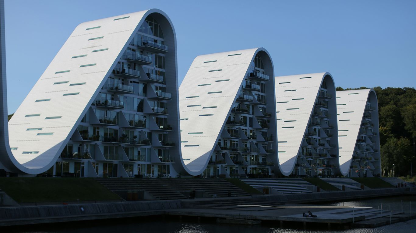 a row of buildings sitting next to a body of water