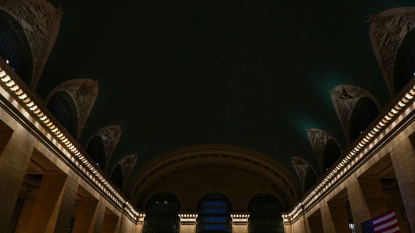 the ceiling of a large building with columns and lights
