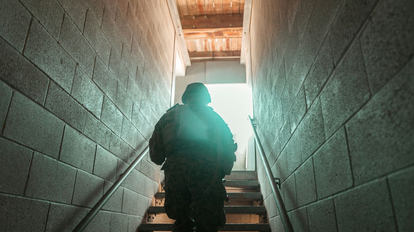 man in black jacket walking on staircase