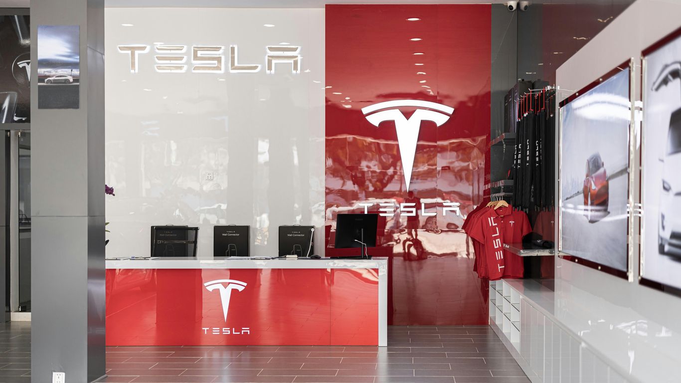 a tesla store with a red and white wall