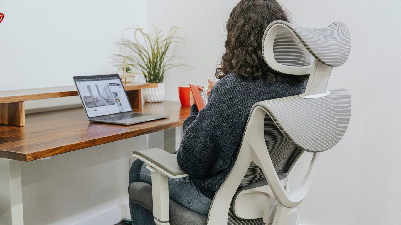 a woman sitting at a desk with a laptop