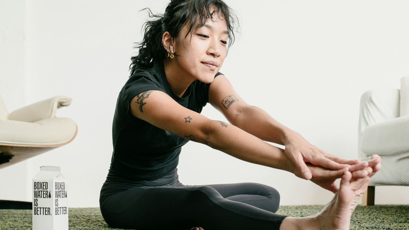 a woman sitting on the floor with her legs crossed
