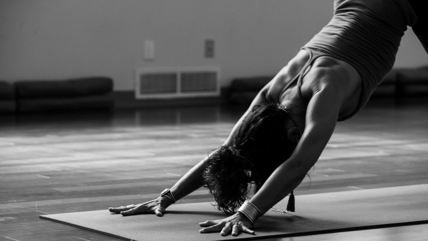 Person practicing yoga on a cushioned mat