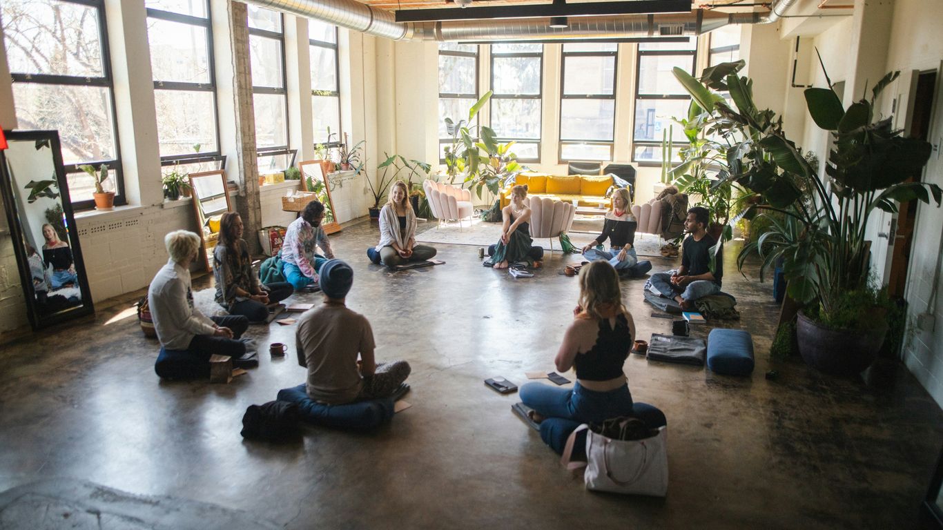 a group of people sitting in a circle in a room