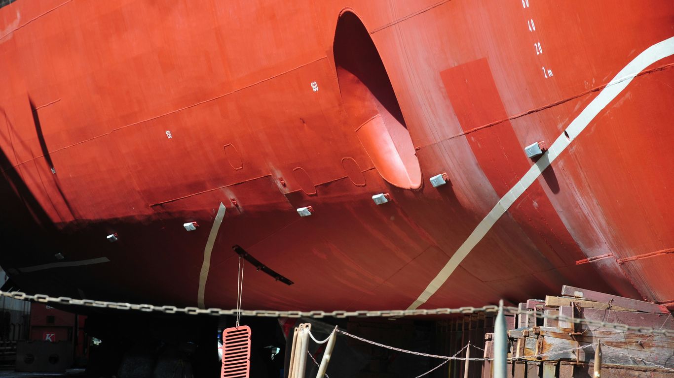 a large red boat sitting in a dry dock