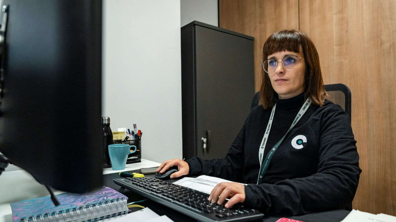 A woman is working at her office desk.