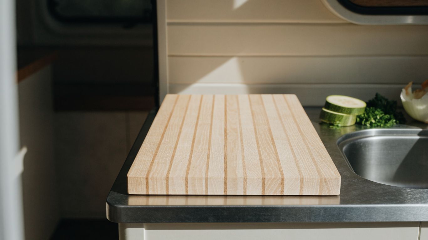 Compact camper counter with a pale maple cutting board