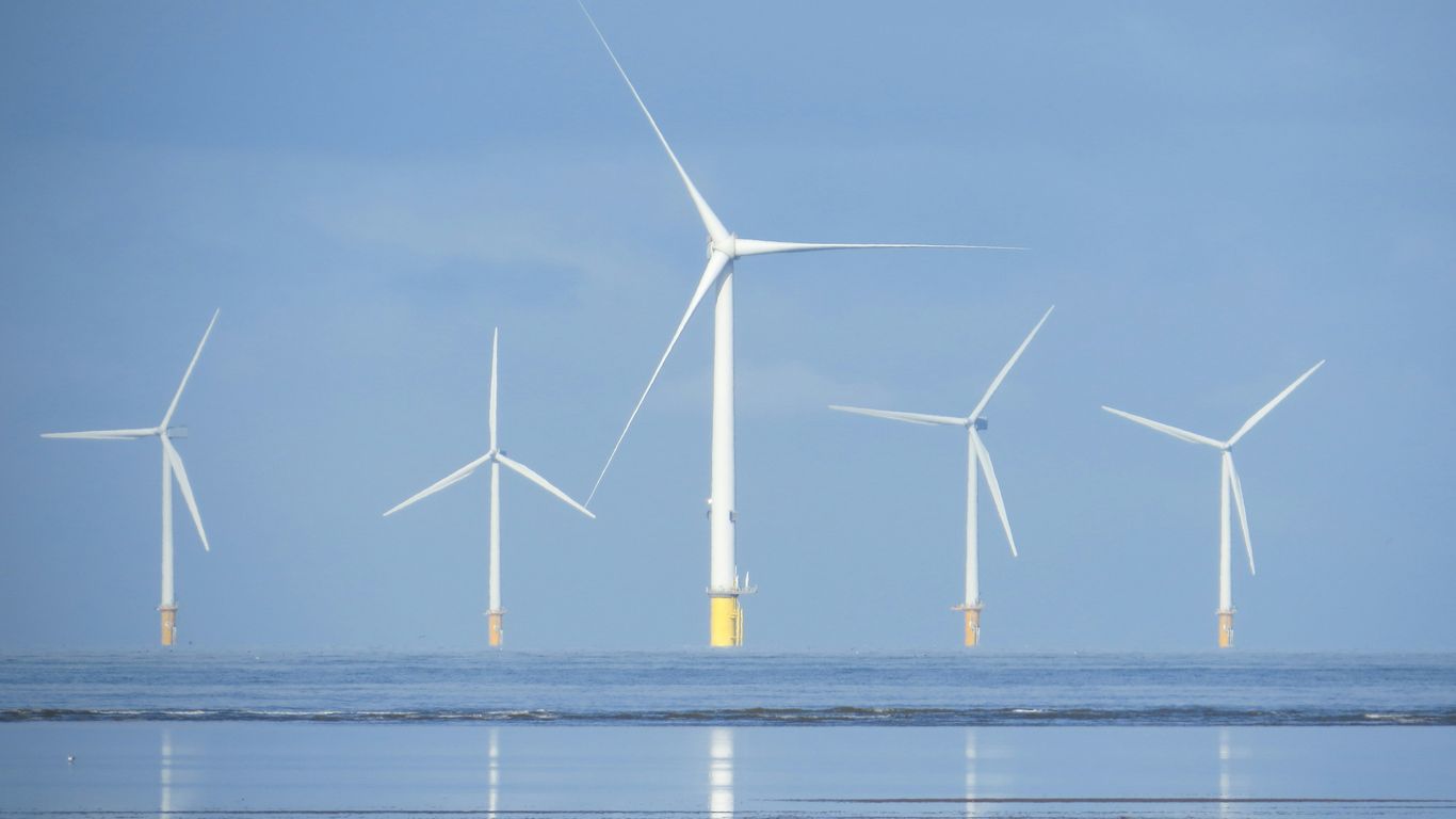 a group of wind turbines in the ocean