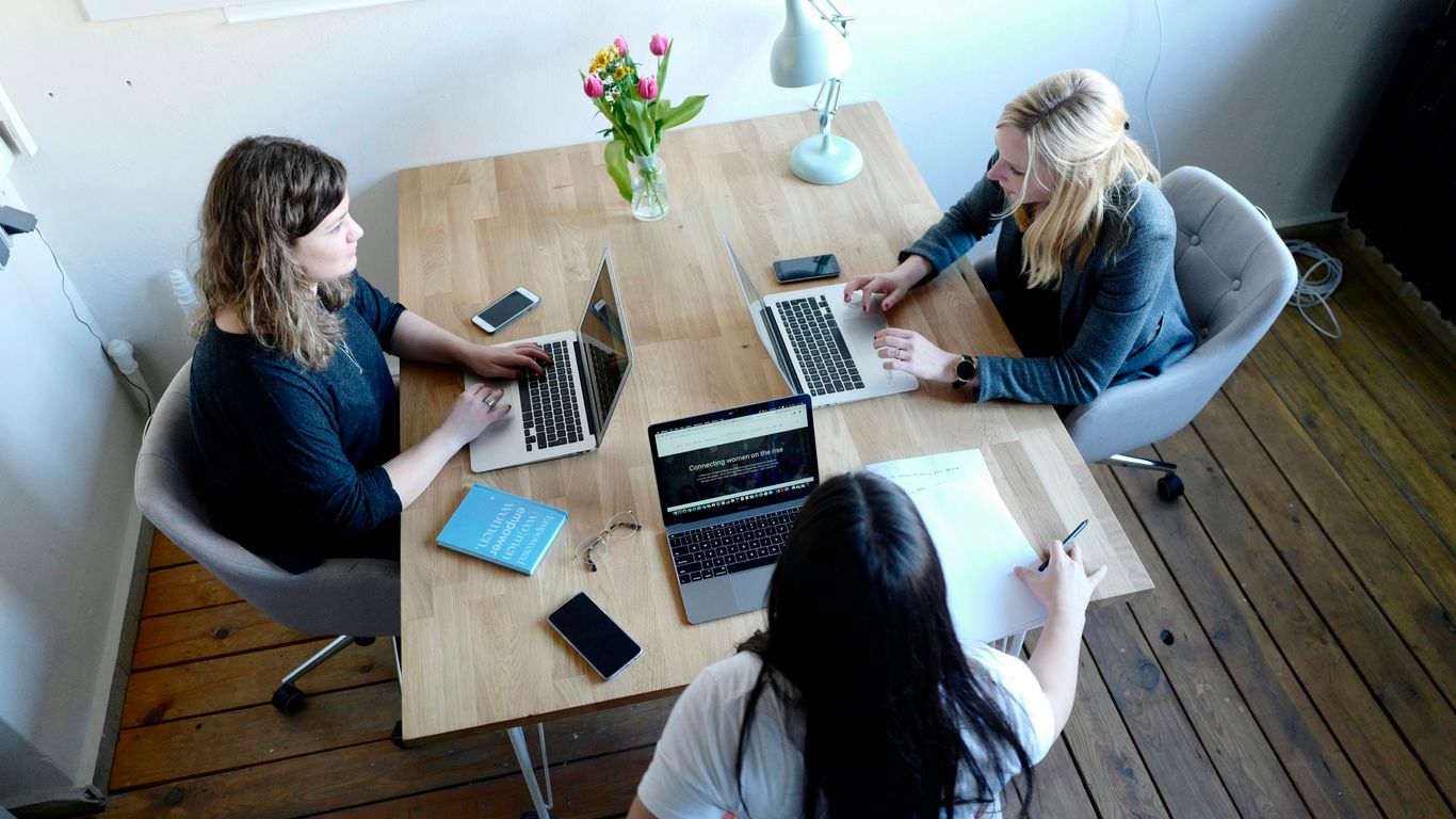 Professional project managers discussing a floor plan