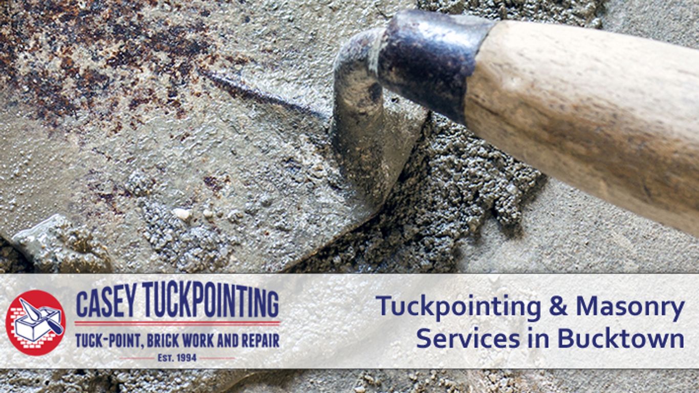 A trowel spreads cement for tuckpointing and masonry services.