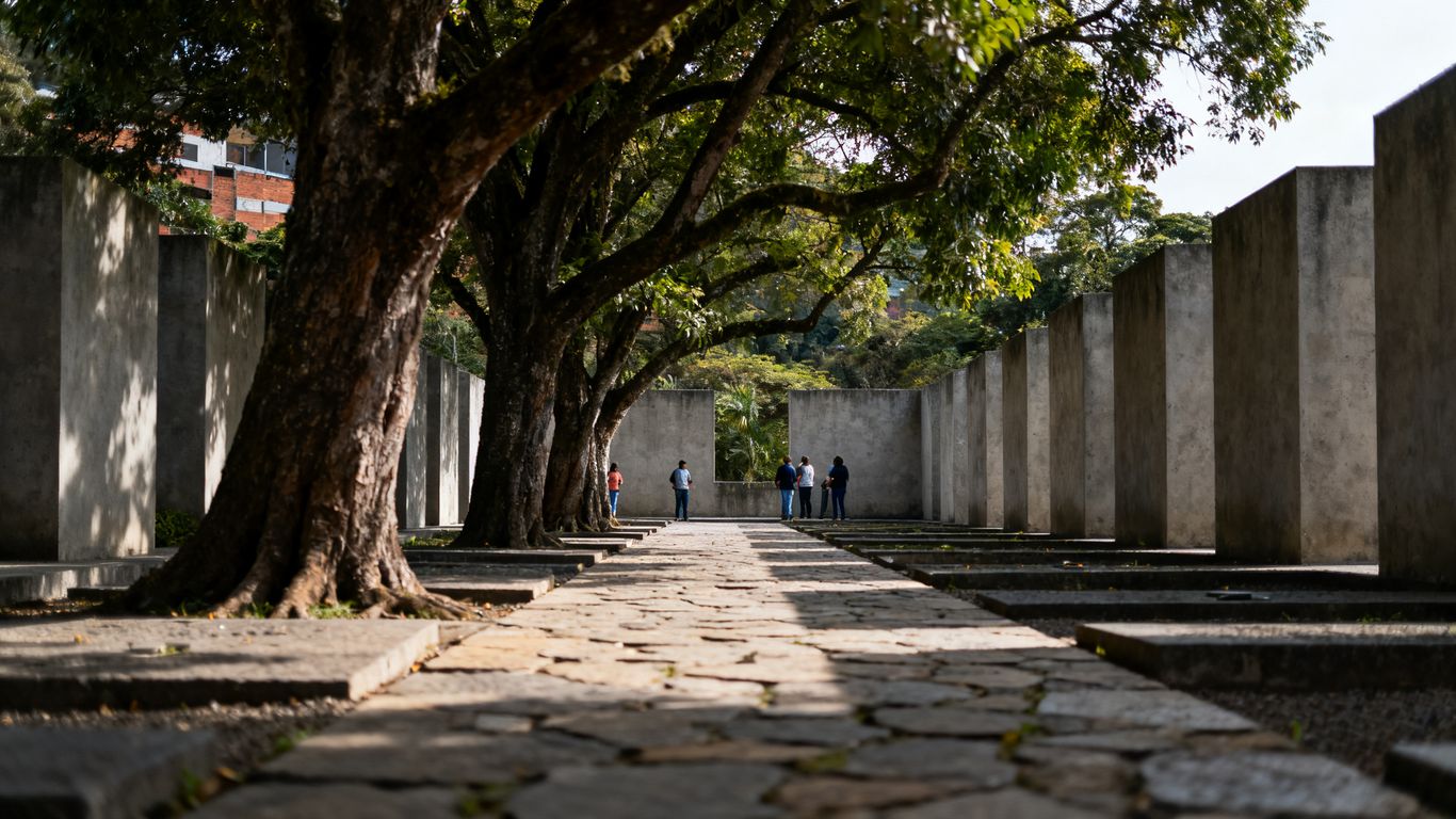 Peace memorial courtyard with visitors among trees