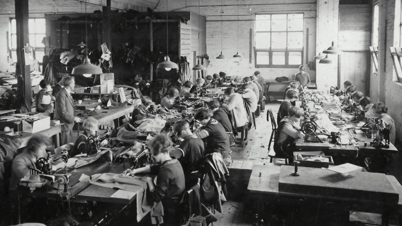Factory worker inspecting athletic shoes