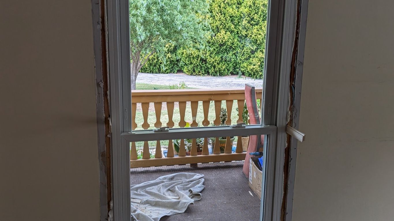 A new window is being installed in a room.