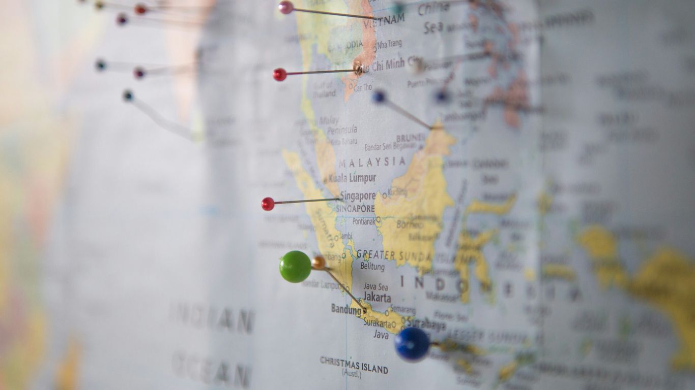 Profissional analisando rotas de transporte com mapas digitais