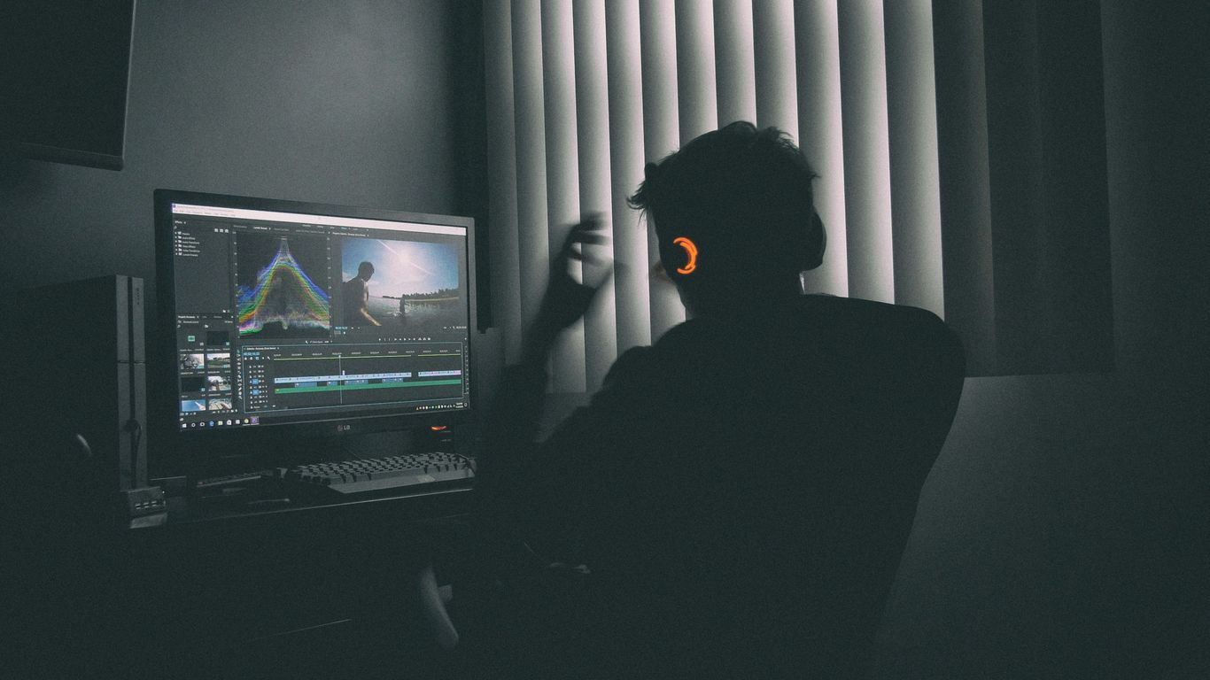 Artistic director reviewing footage on a high-definition monitor