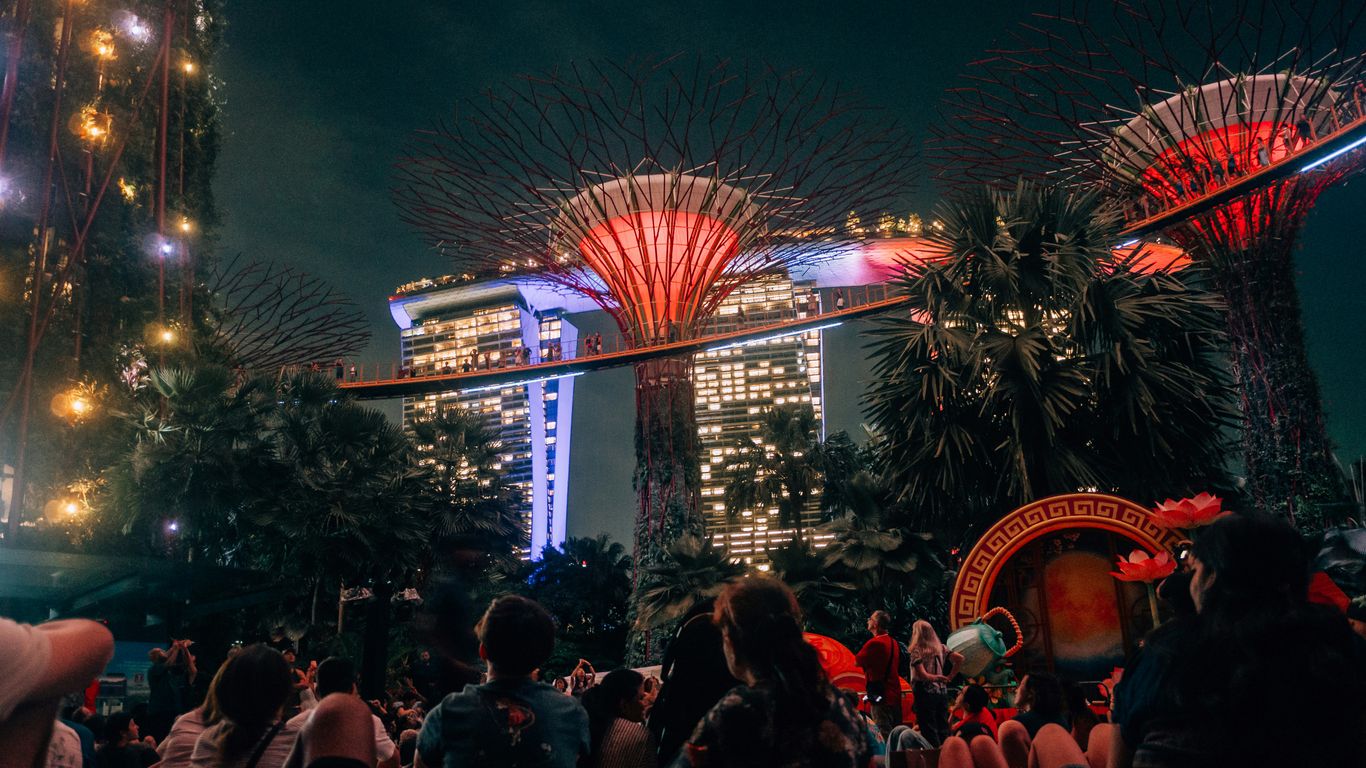 People gathered at gardens by the bay at night