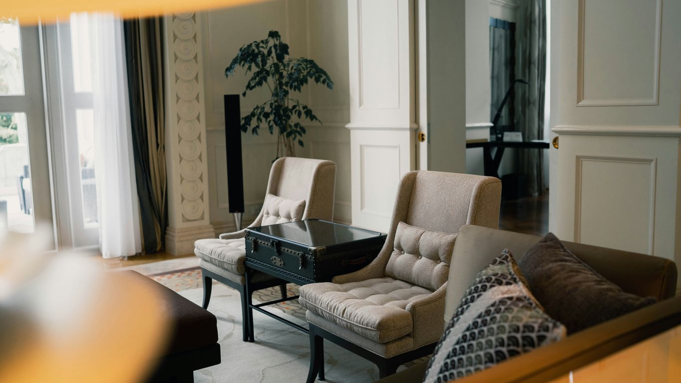 black and white sofa chair near white window curtain
