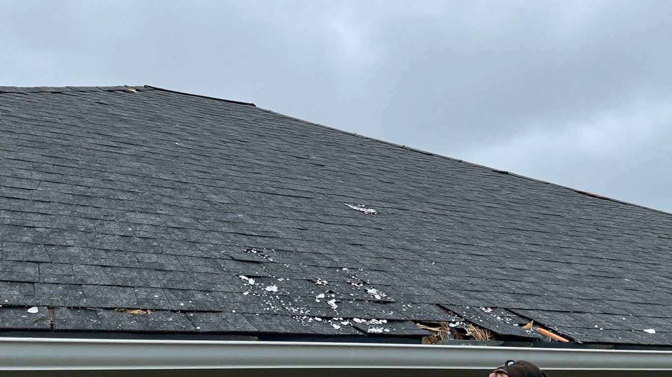 Damaged roof after hail and wind storm.