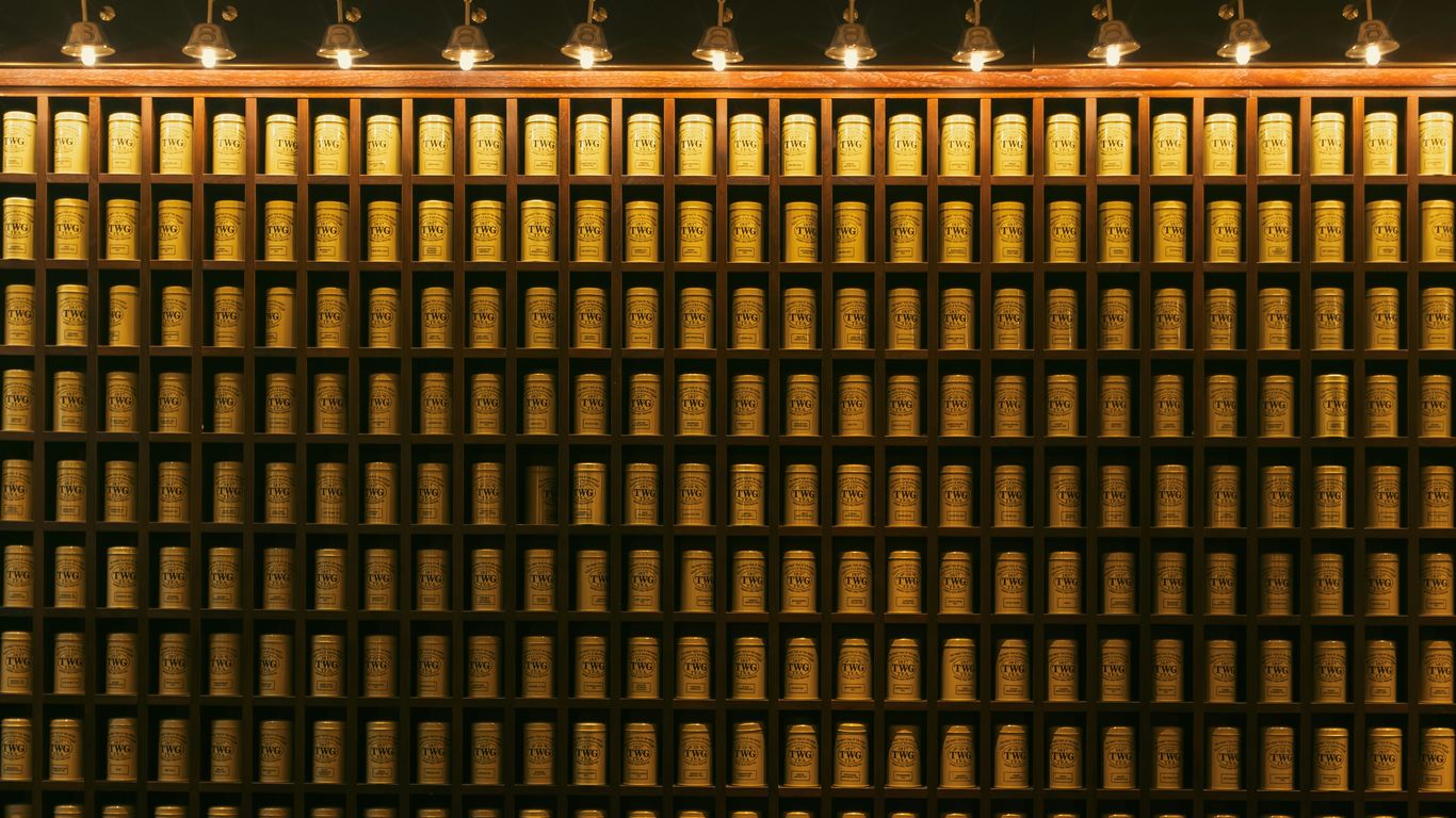 Tea shop shelves containing colorful tins