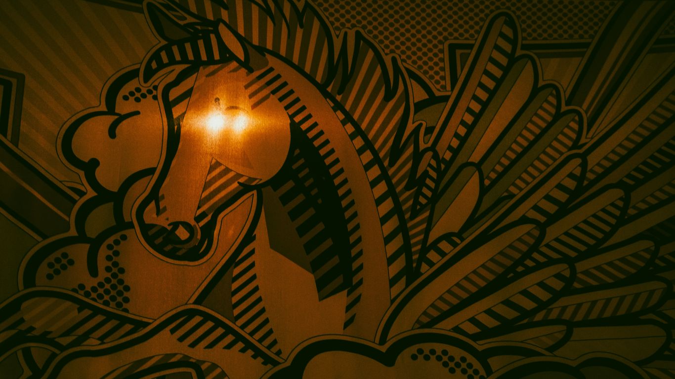 a close up of a horse head on a wall