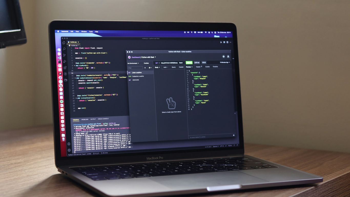 a laptop computer sitting on top of a wooden desk
