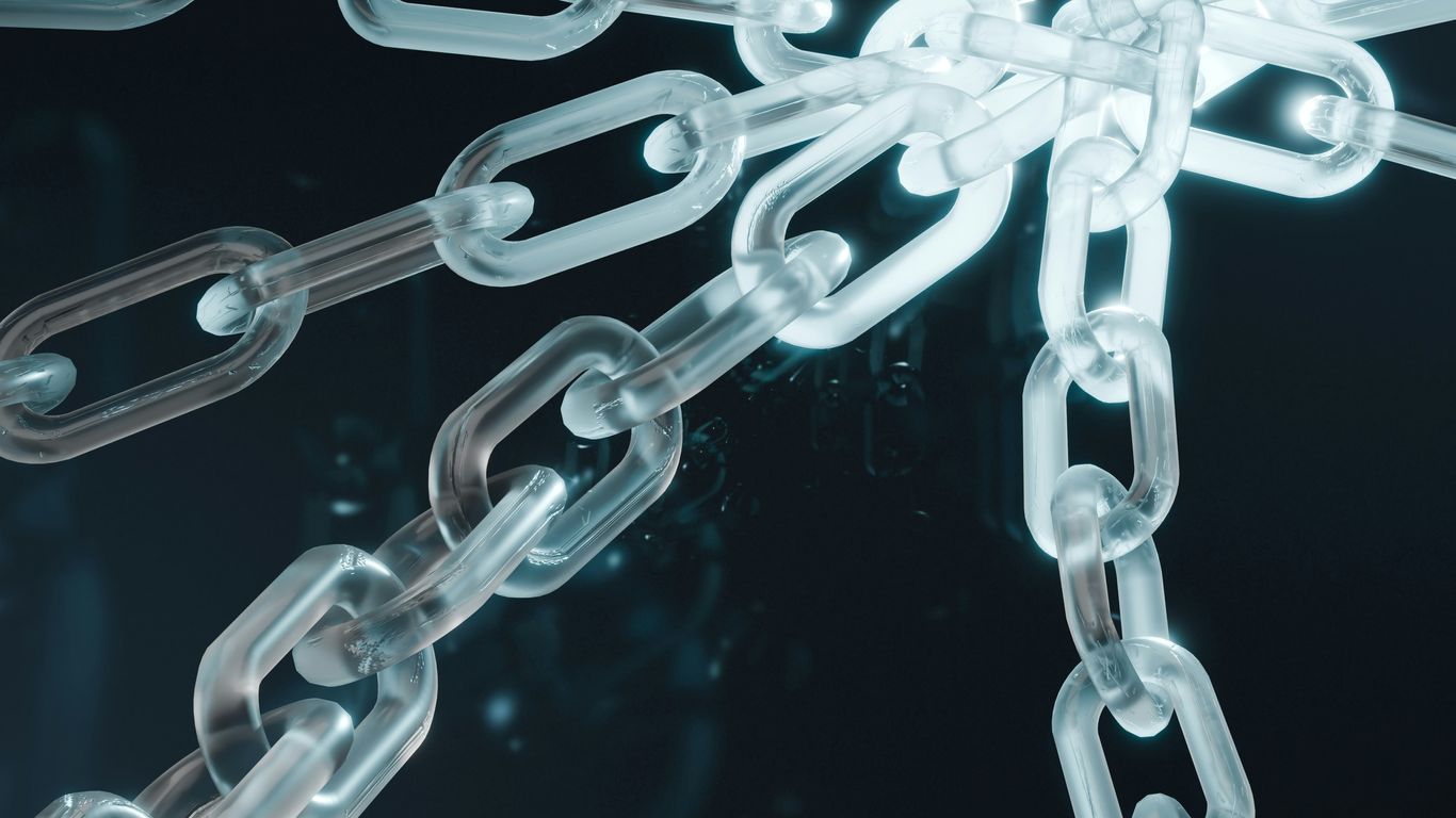 A close up of a metal chain on a black background