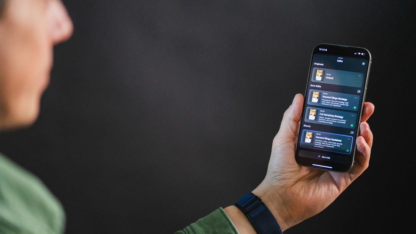 Man holding smartphone with app interface