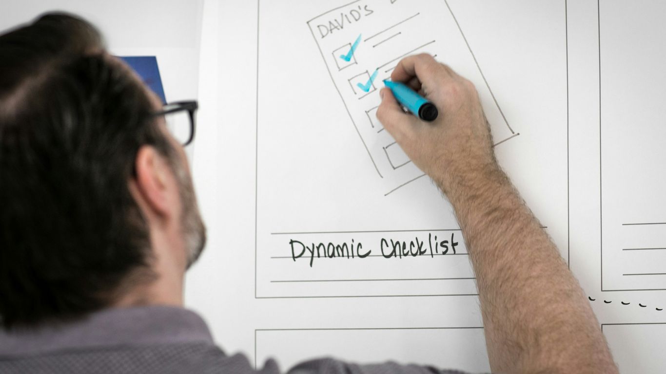 person writing on whiteboard