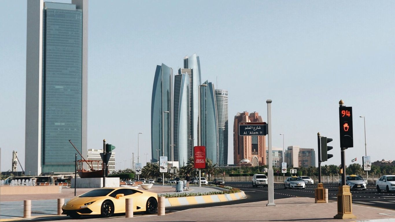 yellow car on road near building during daytime
