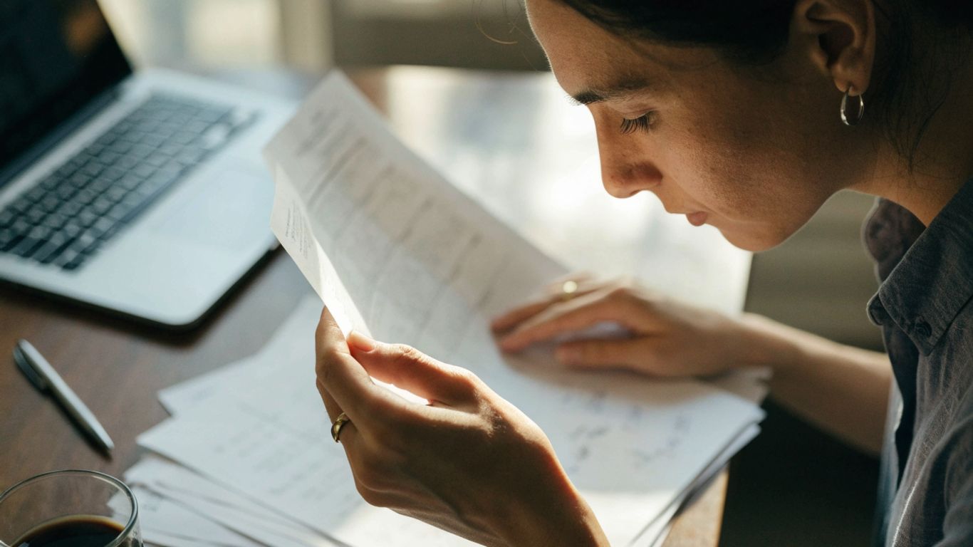 Careful trader reviewing payout records and account notes