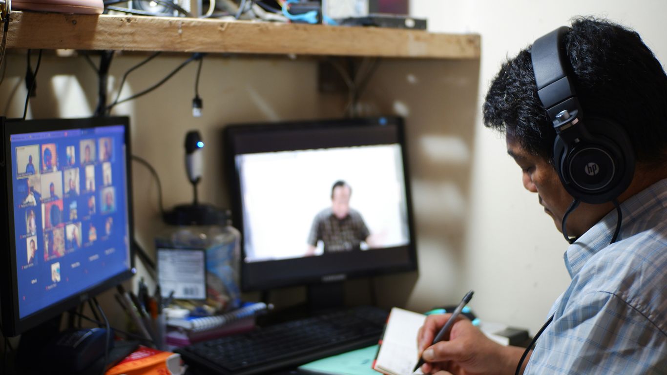 man in white and black plaid dress shirt holding white paper