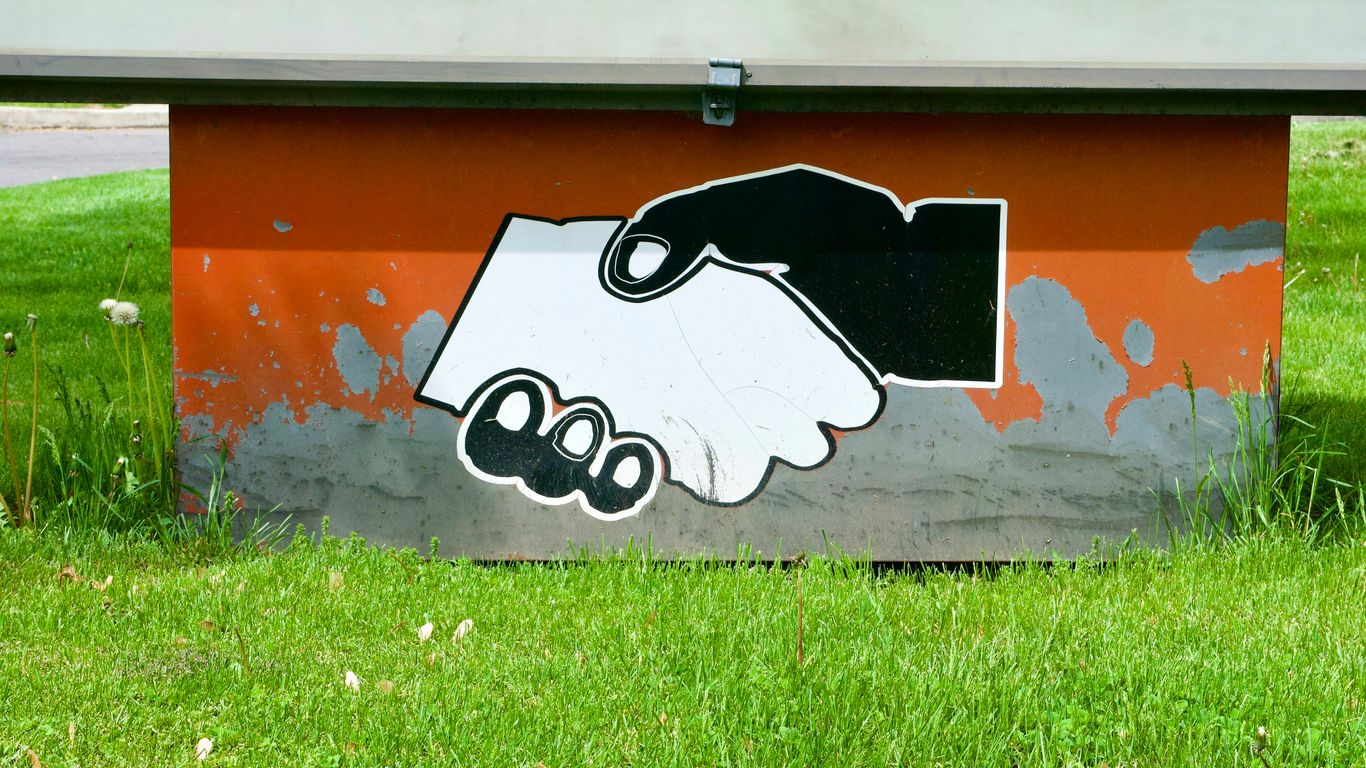 black and white cow graffiti on orange wall