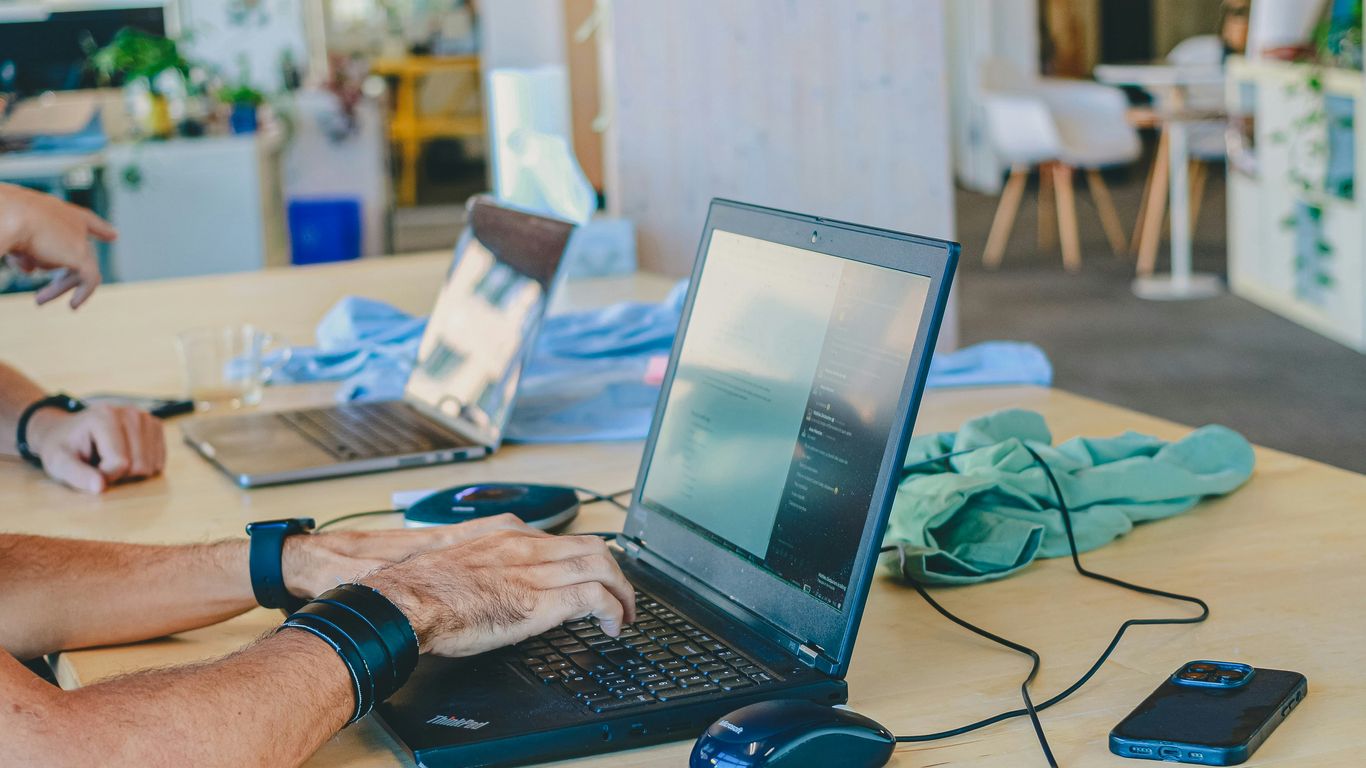 People working on laptops at a table