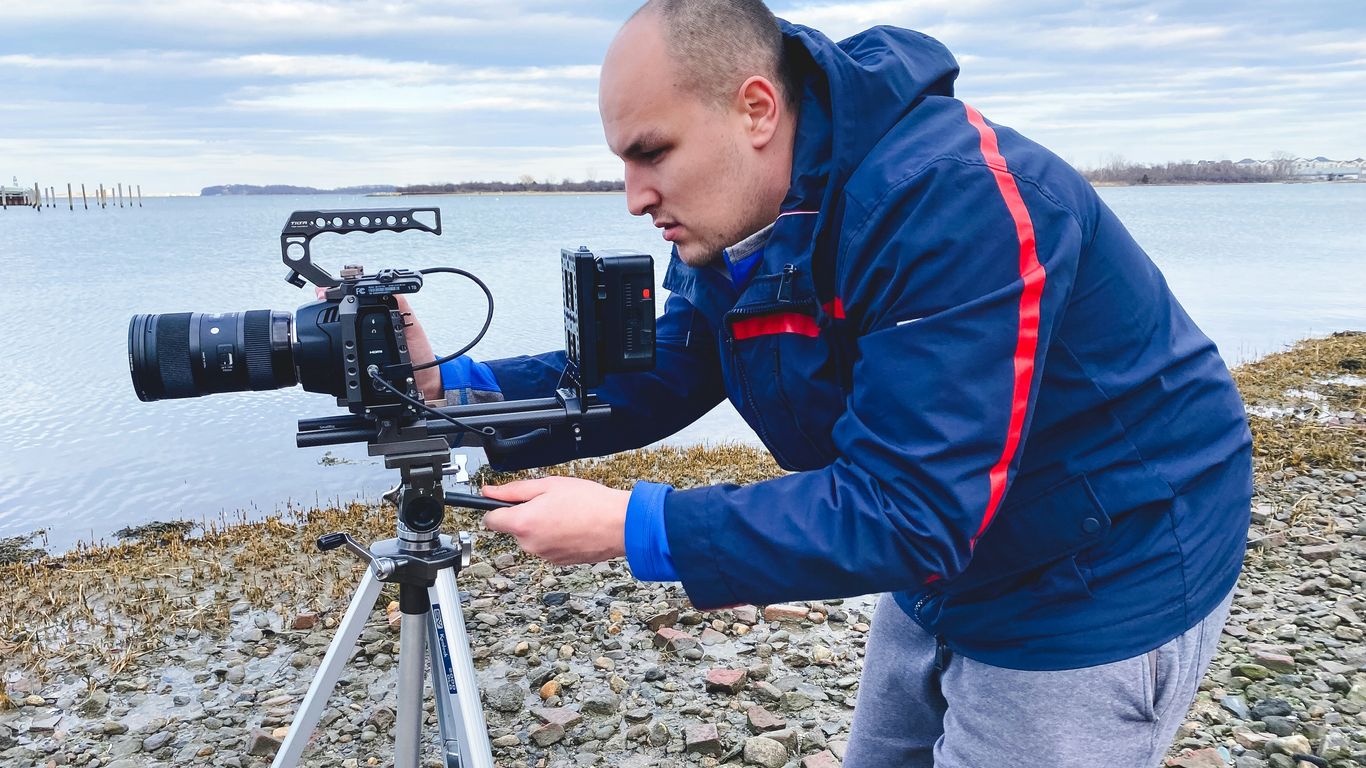 Cinematographer filming an interview
