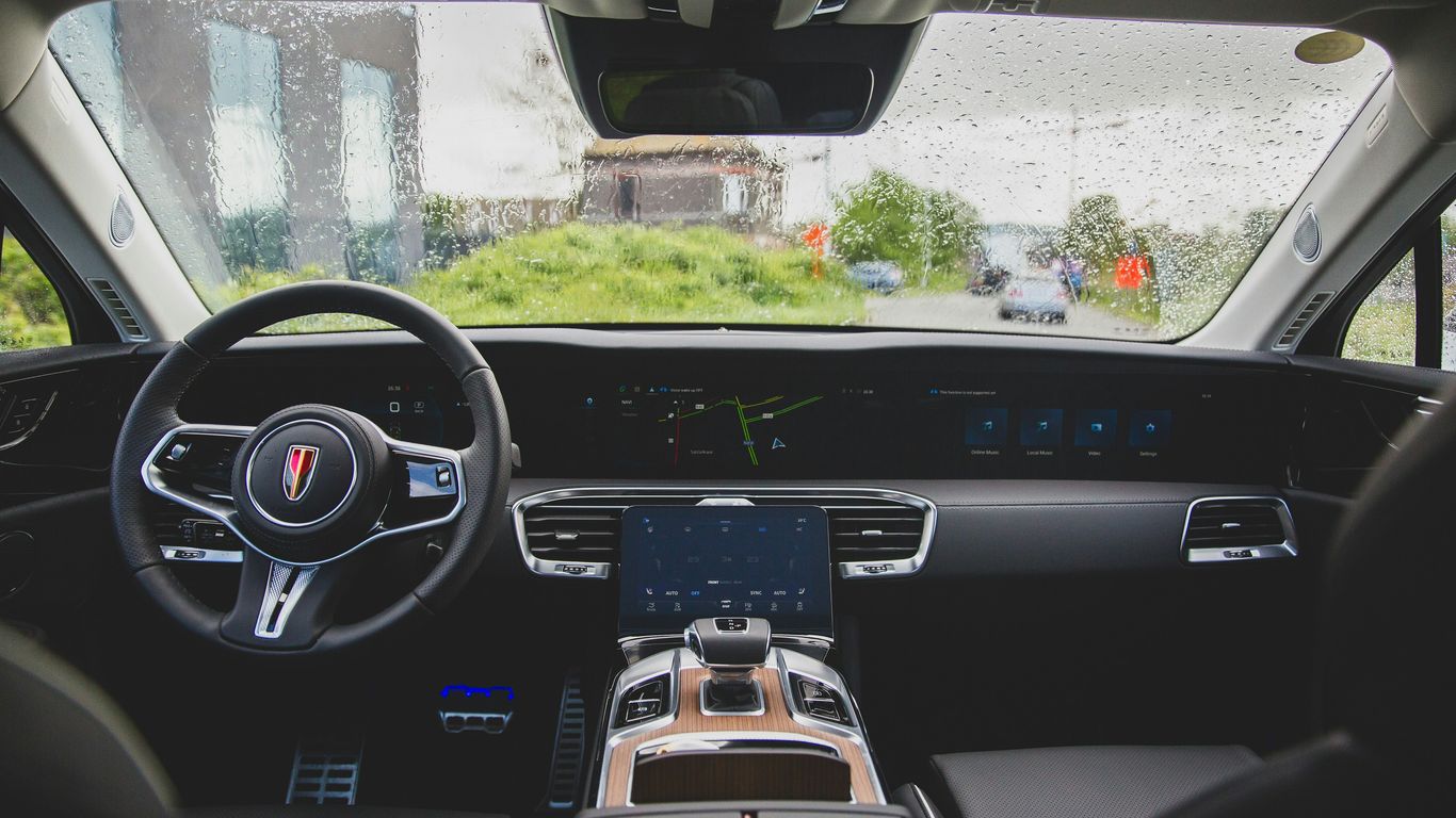 the inside of a car with a steering wheel and dashboard
