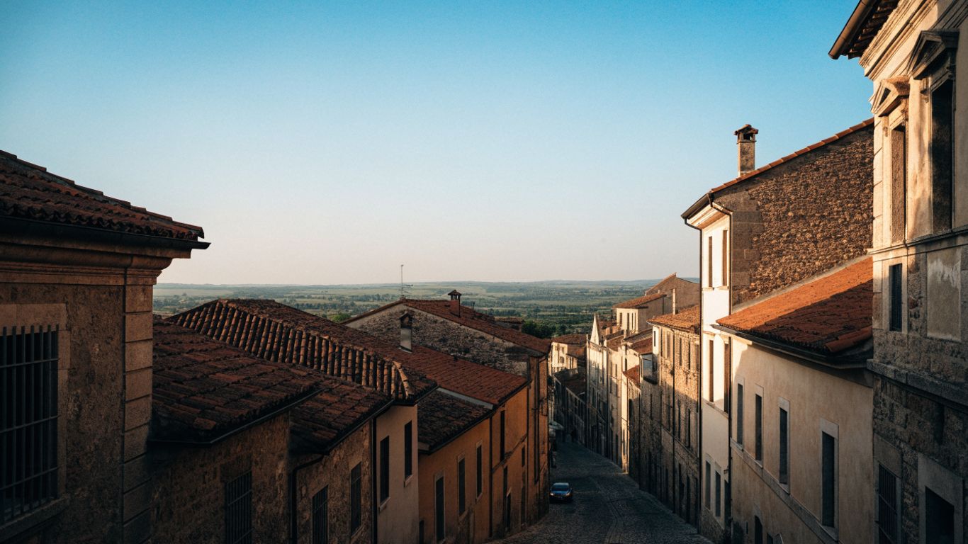 Historic Recanati rooftops beneath a wide sky