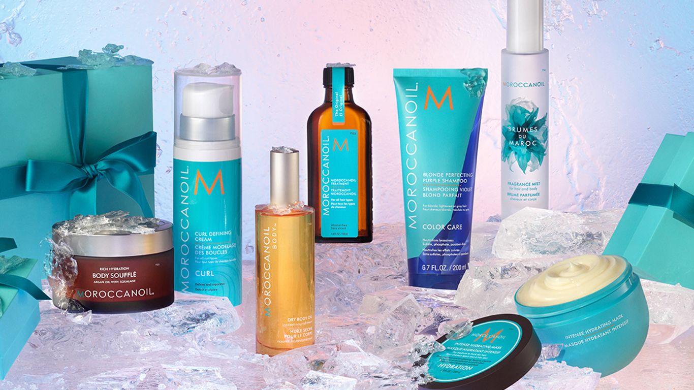 Moroccanoil hair care products displayed with ice and gift boxes.
