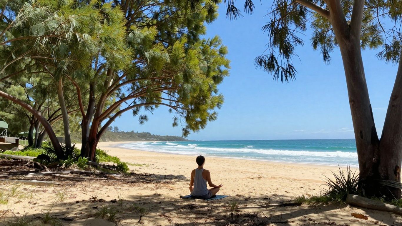 Person meditating on an Australian beach at sunrise.