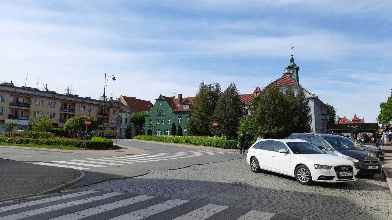 a white car parked on the side of a road