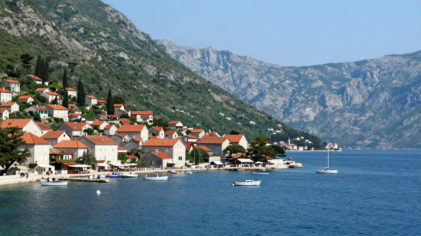 Montenegro coastal village with blue sea and green mountains.