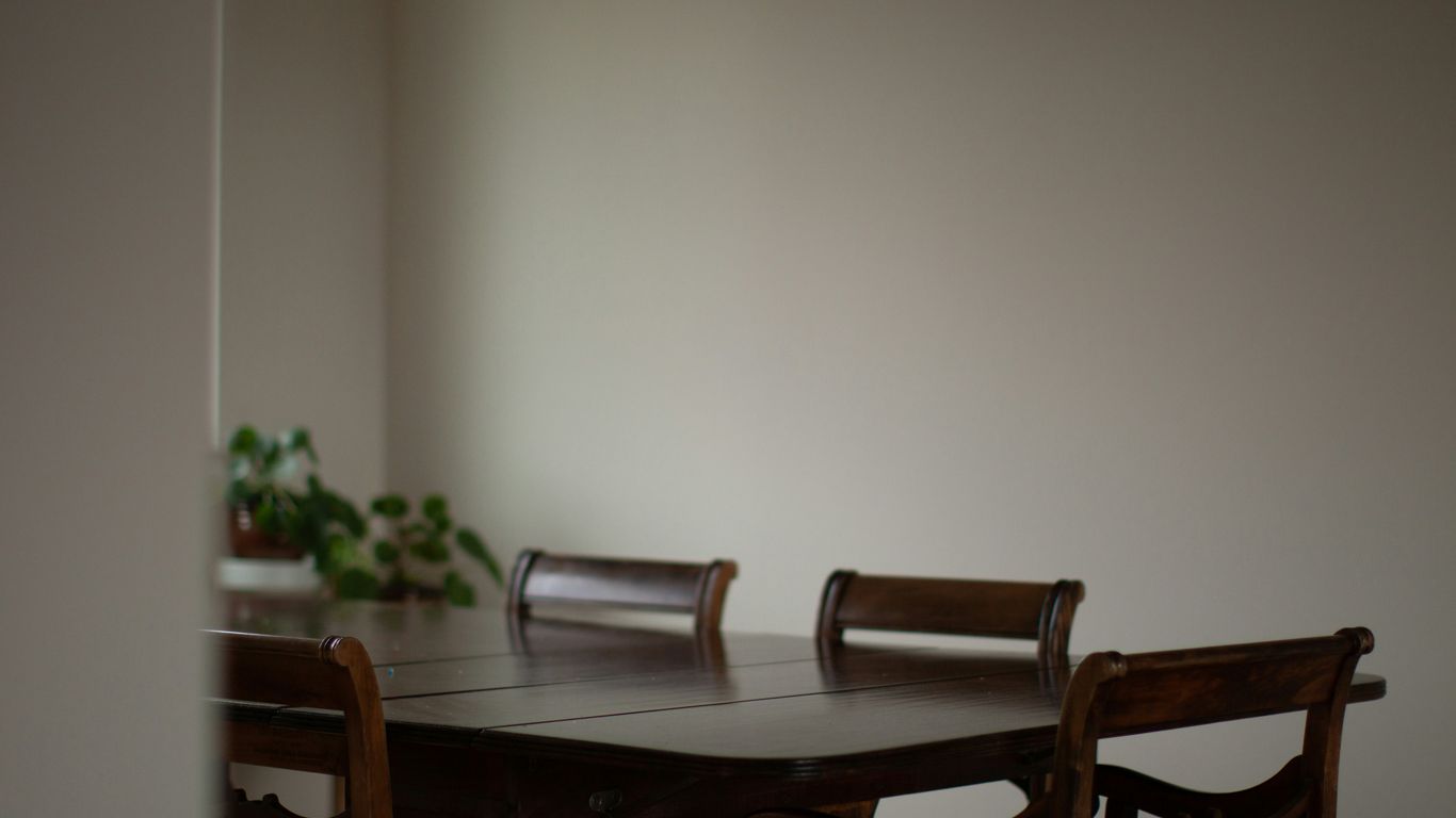 Six dining chairs around stone table