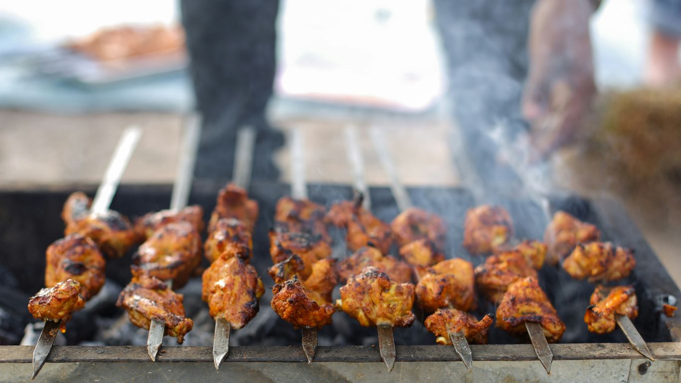 Sizzling charcoal satay grills at night