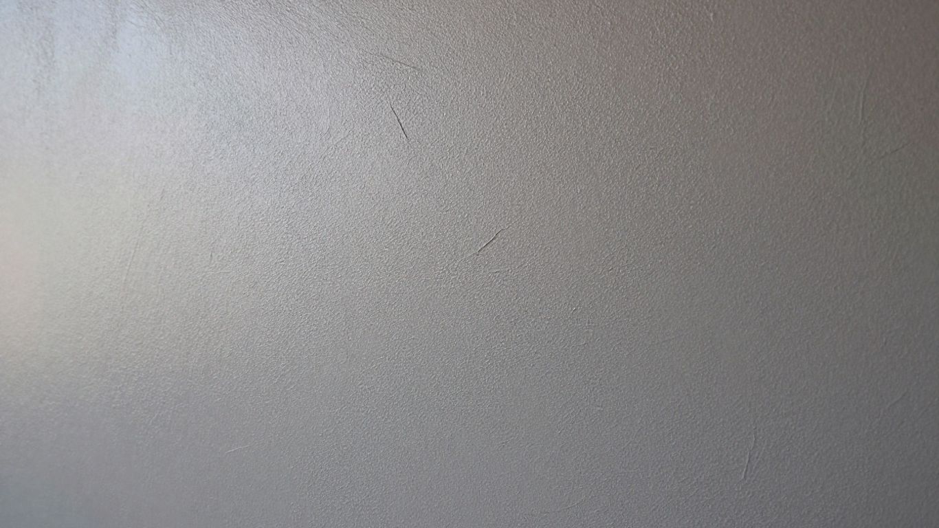 Textured wall with subtle color variations.
