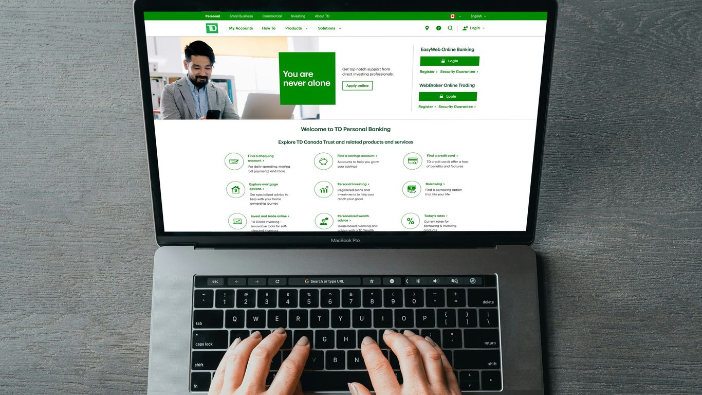 a person typing on a laptop with their hands