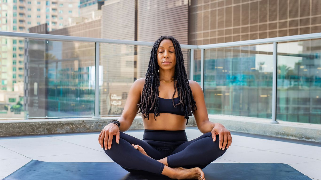 a woman sitting on a mat