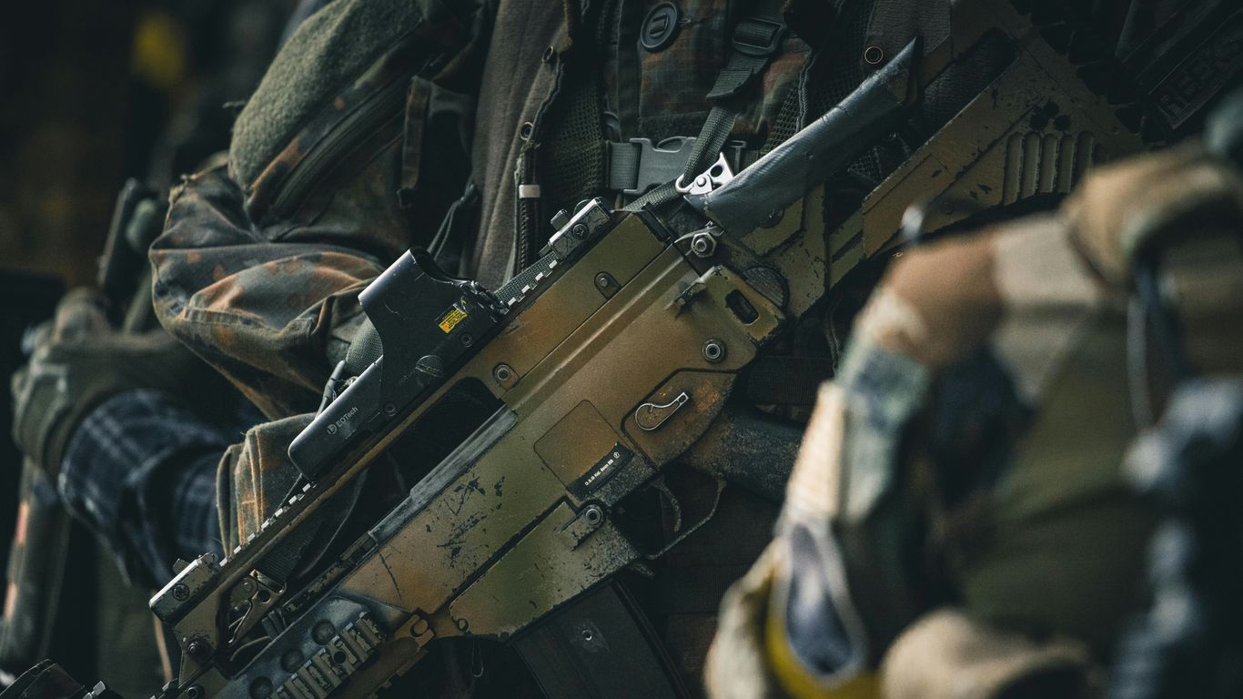 a close up of a rifle on a person's arm