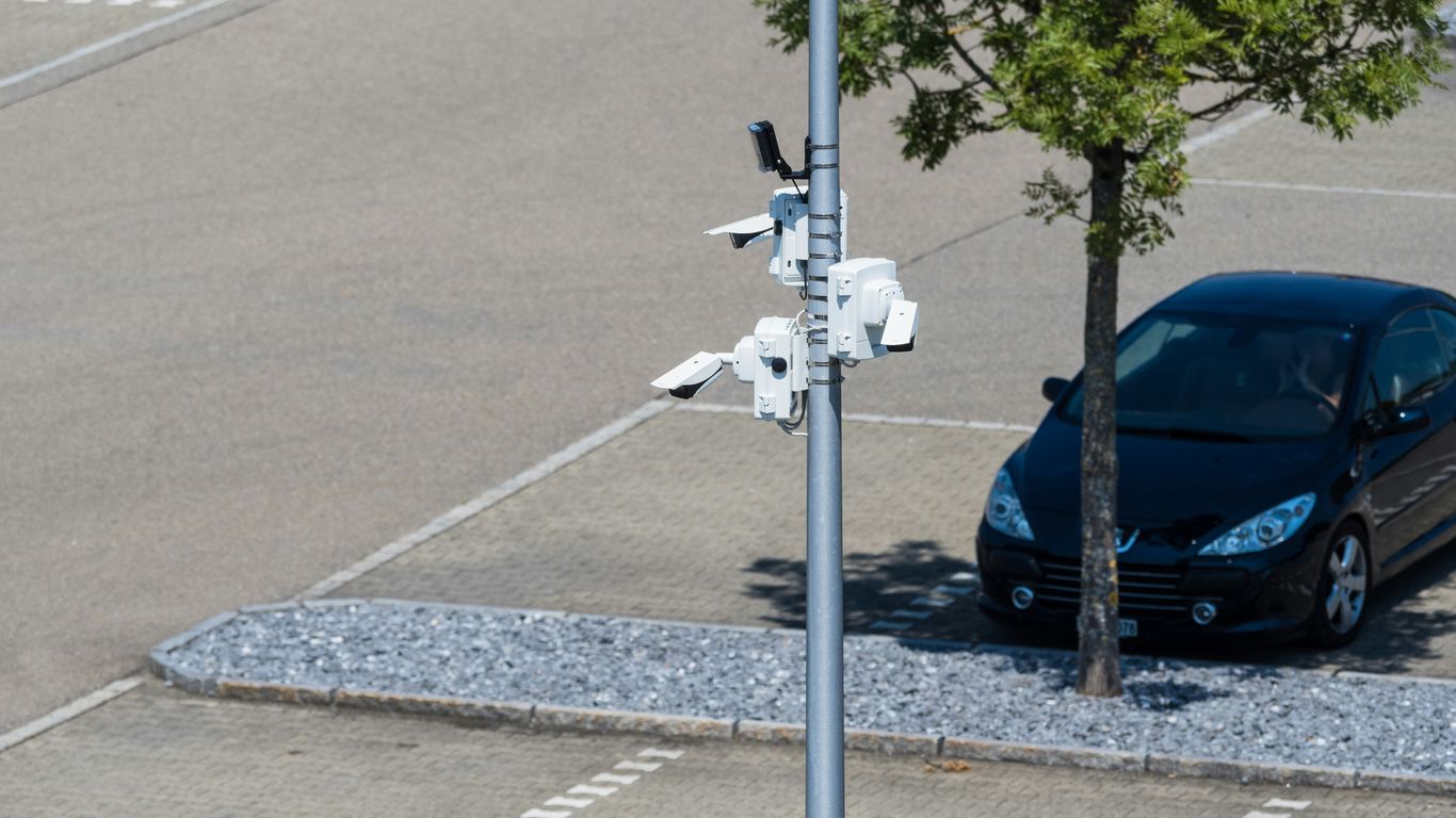Security cameras monitor a parking lot.