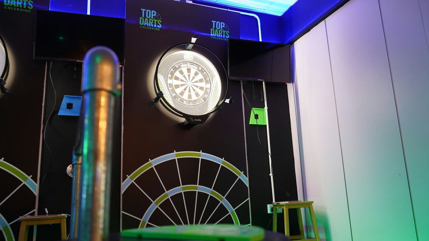 Modern darts playing area with illuminated boards
