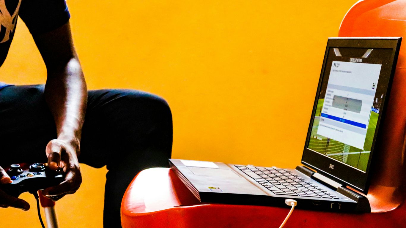 a man sitting in a chair with a laptop on his lap