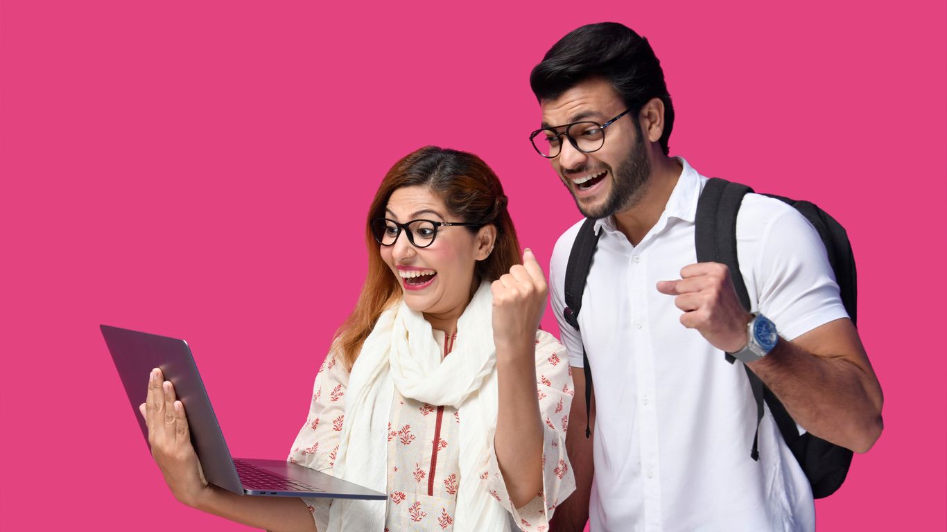 a man and a woman looking at a laptop